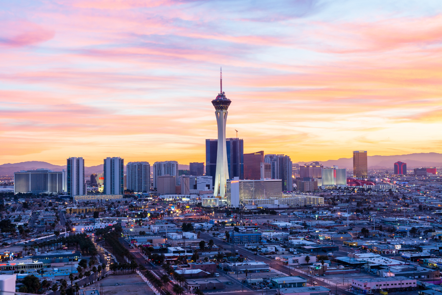 Las Vegas skyline at sunset featuring the Stratosphere Tower, surrounded by city buildings and vibrant colors in the sky, representing the dynamic environment for digital marketing services.