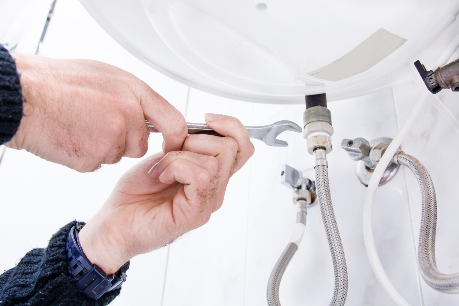 Photo Of Plumber Fixing Plumbing Issue