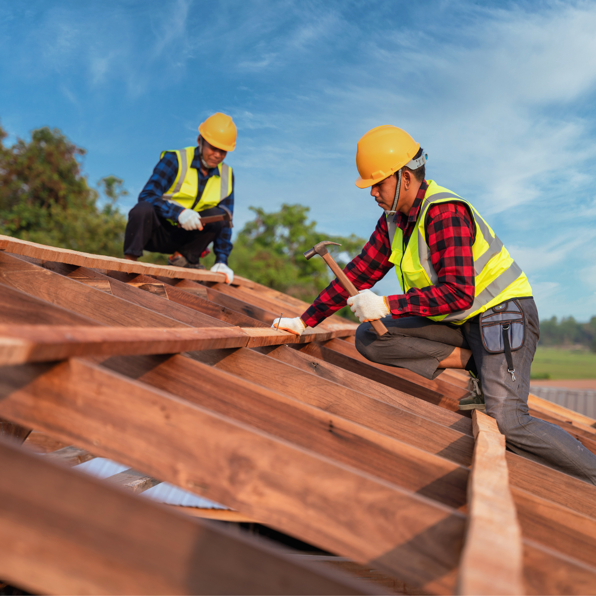 Two Roofers building a roof