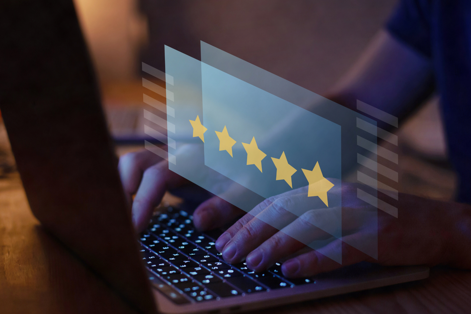 Person typing on a laptop with an overlay of five yellow stars, symbolizing customer reviews and online reputation management for digital marketing success.