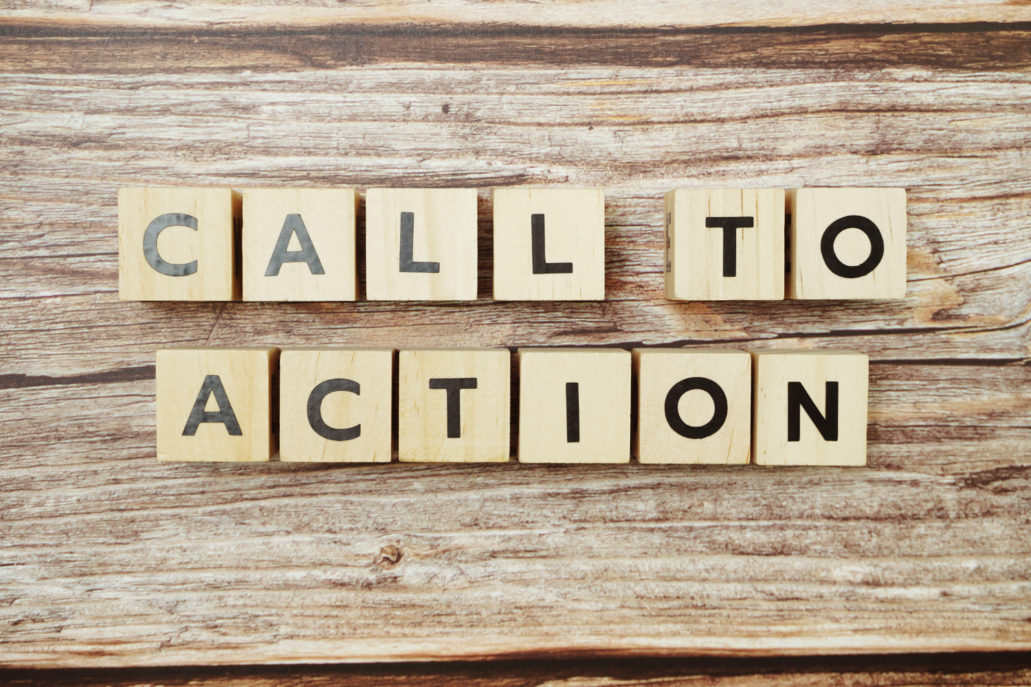 Wooden blocks spelling "CALL TO ACTION" on a rustic wooden background, symbolizing marketing strategies for HVAC professionals to engage clients and enhance business growth.