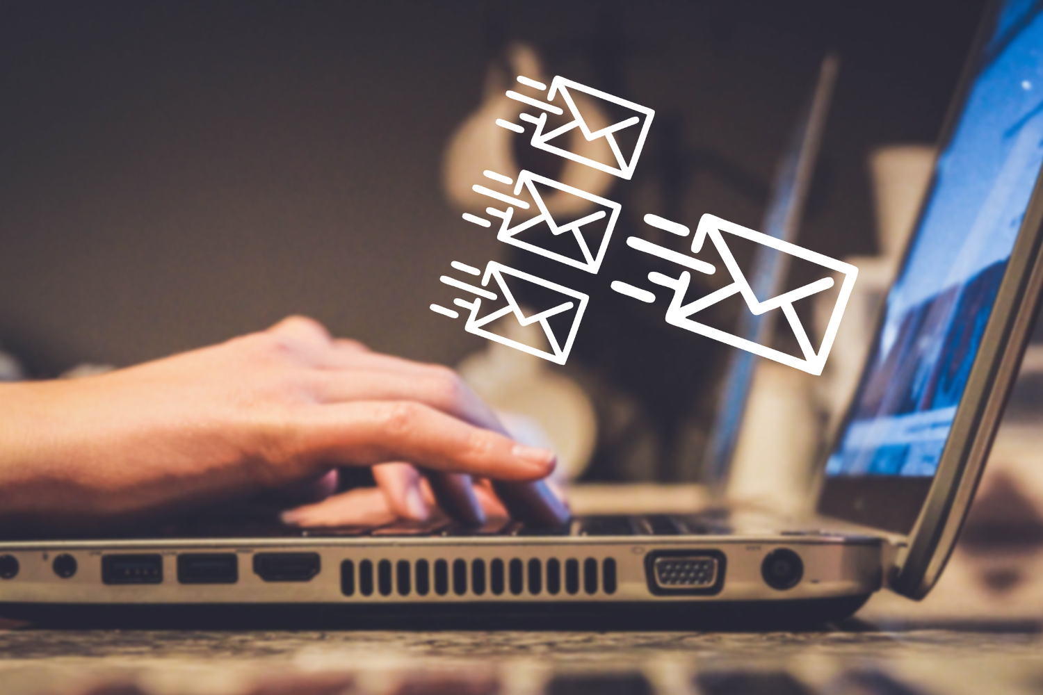 Person typing on a laptop with animated email icons, illustrating email marketing services by Solitude Marketing for driving customer engagement and revenue.